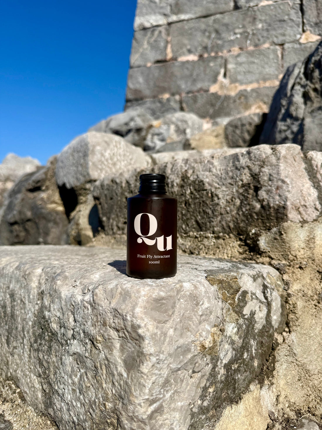 Quiet Utility refill with a rocky background on a sunny day.