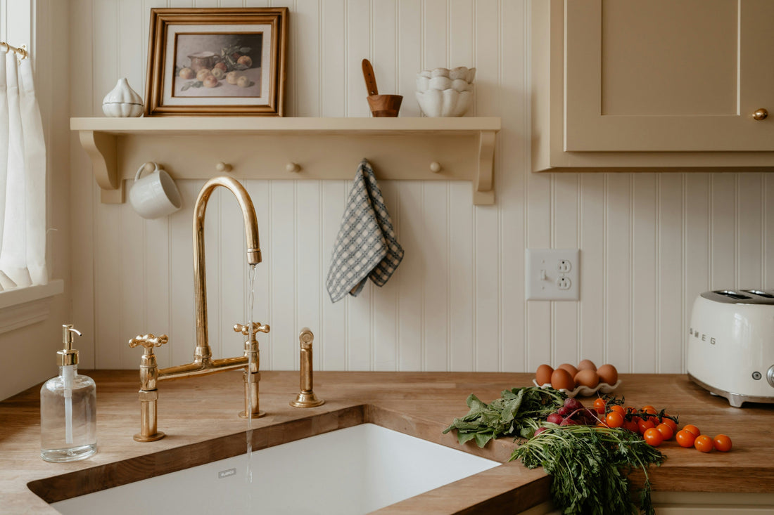 Modern kitchen featuring a farm sink with fresh produce sitting on the counter top with eggs.